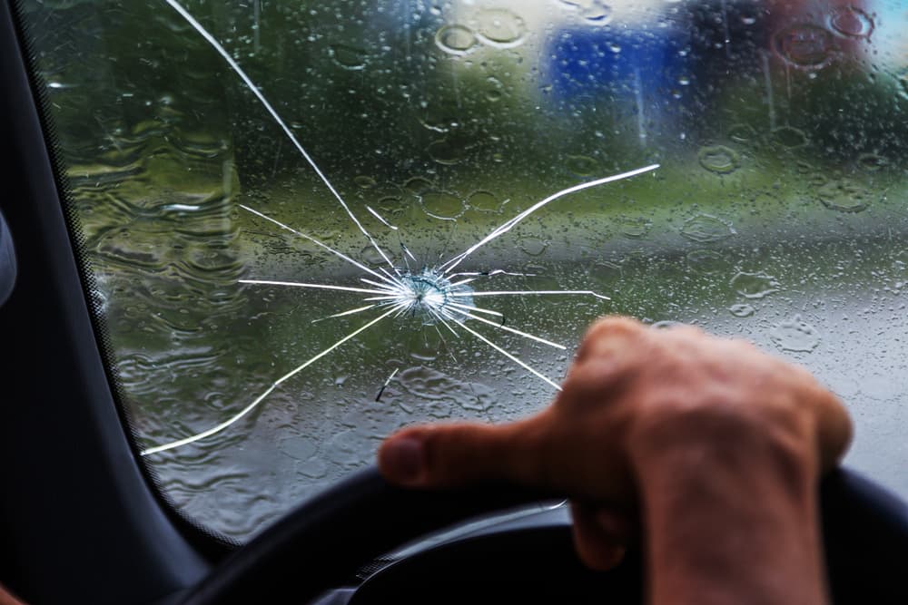 Chipped car windshield during the rain.