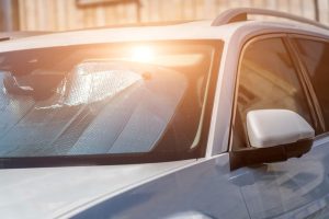Sun reflecting from a car windshield, car with sun visor.